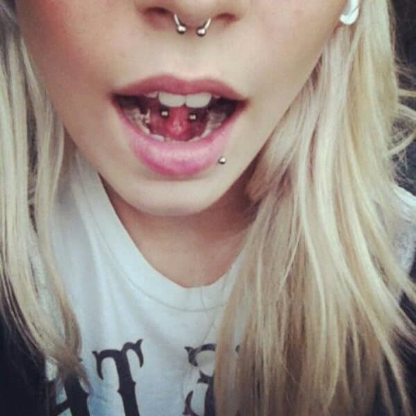 Girl with septum and frenulum piercings