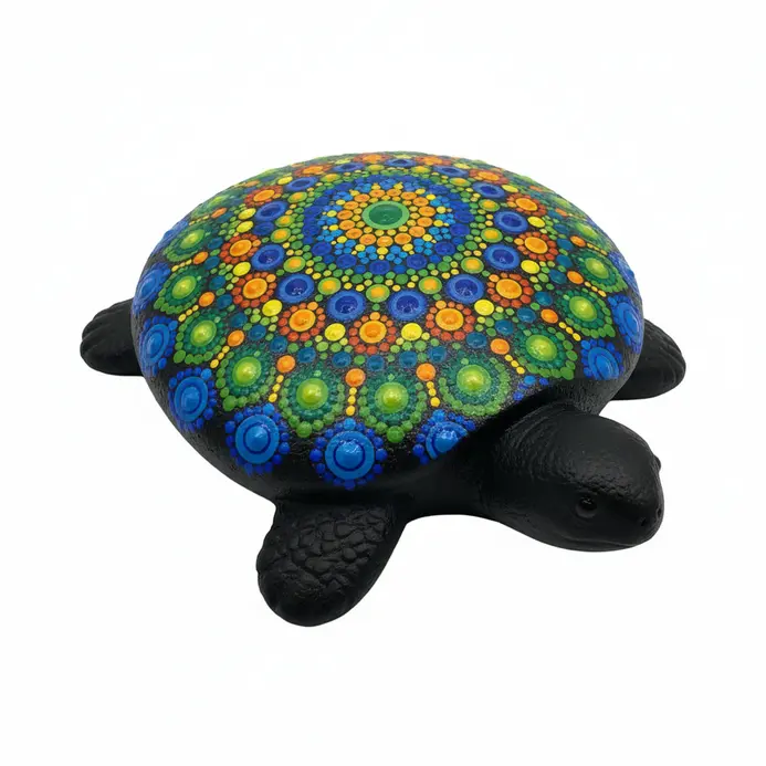 A painted rock turtle with a shell made of colorful concentric dots