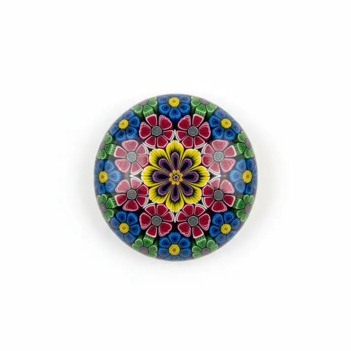 Round glossy polymer clay paperweight with vibrant millefiori pattern