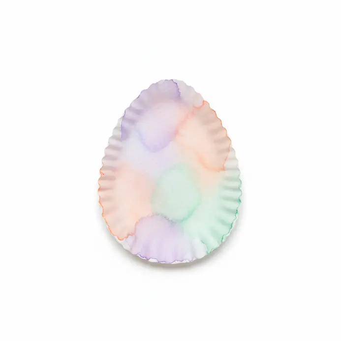 Brightly colored coffee filter Easter eggs with watercolor blends.