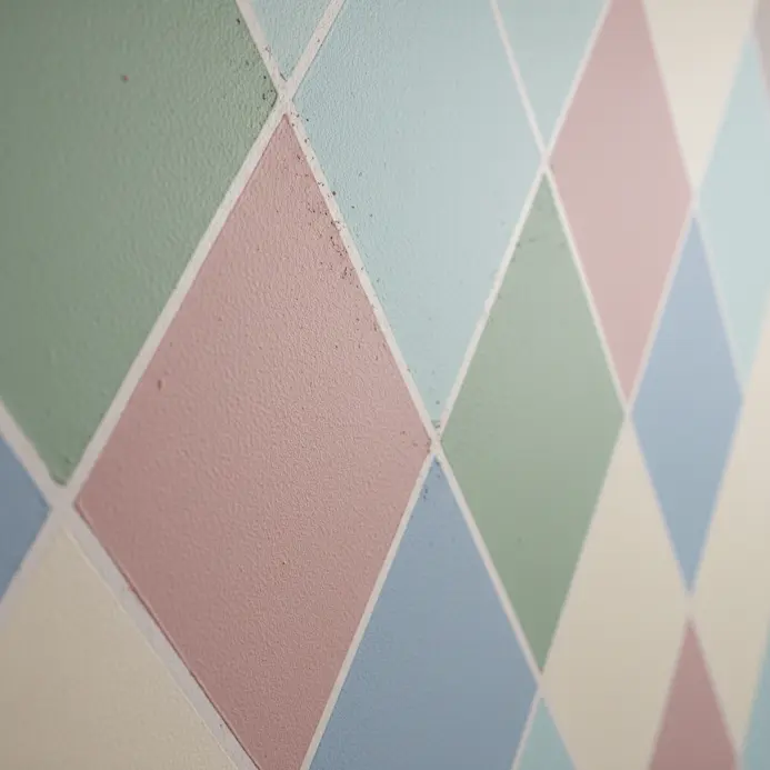 A wall with a repeating triangle pattern in navy blue.