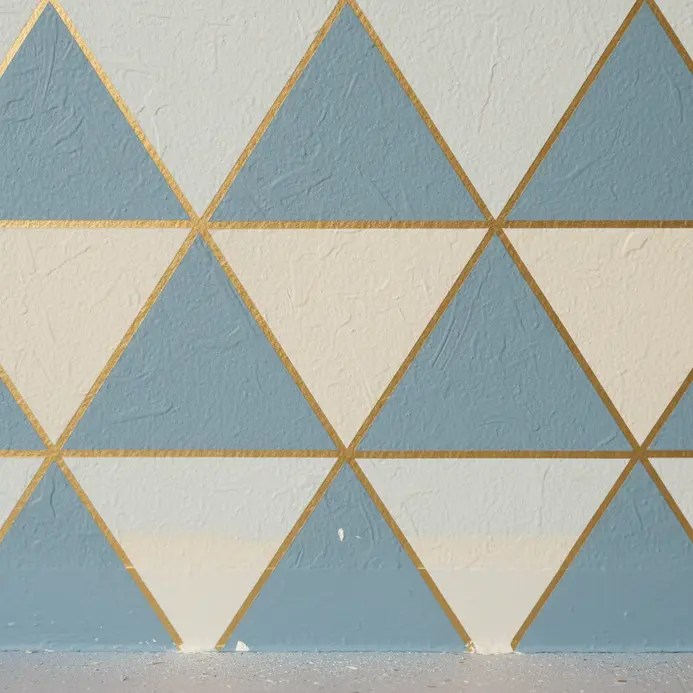 A geometric pattern of black, white, and gray triangles on a feature wall.