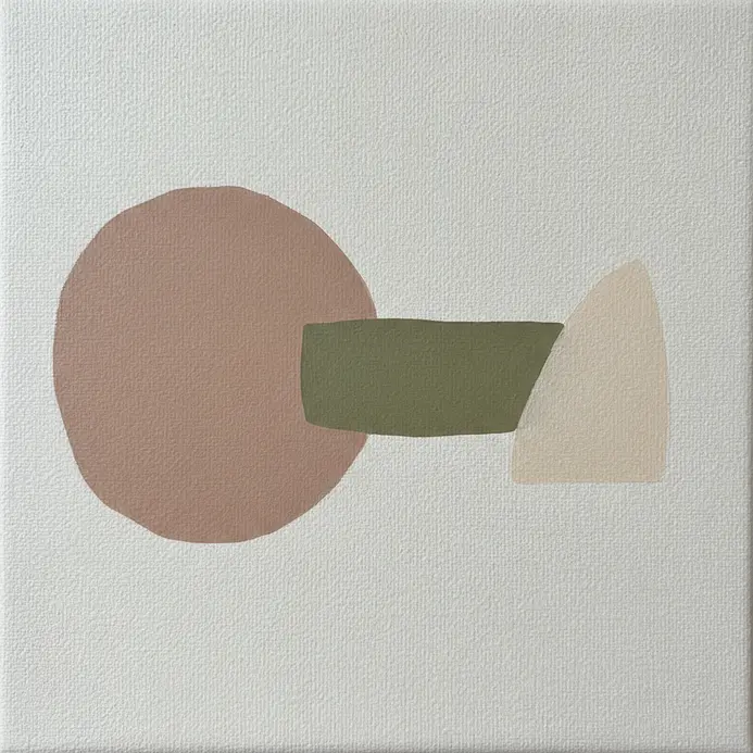 A hand sanding a dried acrylic painting to reveal layers underneath.