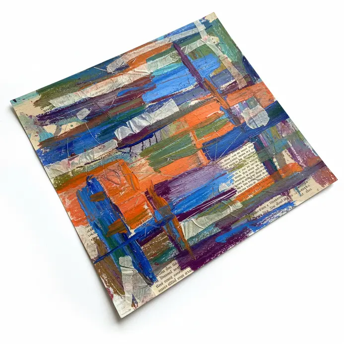 Mixed media piece with oil pastel drawing over layered collage paper