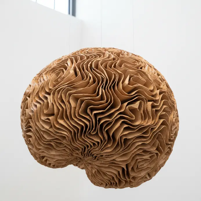 Large-scale paper mache installation suspended from a high ceiling