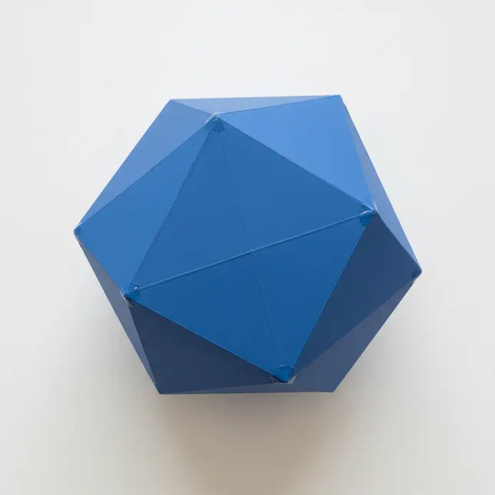 Multi-faceted geometric paper mache sculpture painted in a solid tone