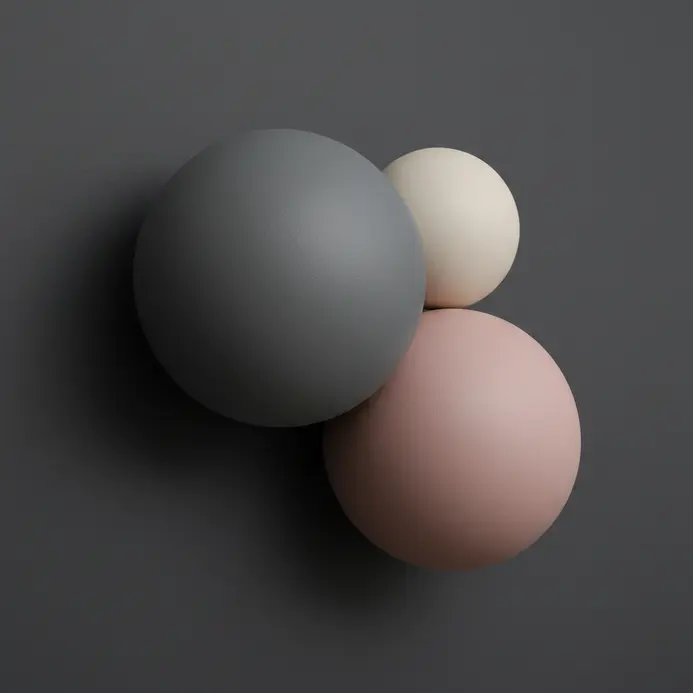 Three smooth spherical paper mache forms mounted on a dark wall