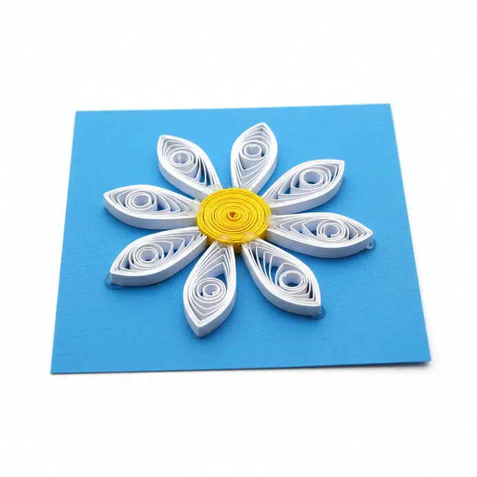 Simple yellow and white paper quilled daisy on a blue background