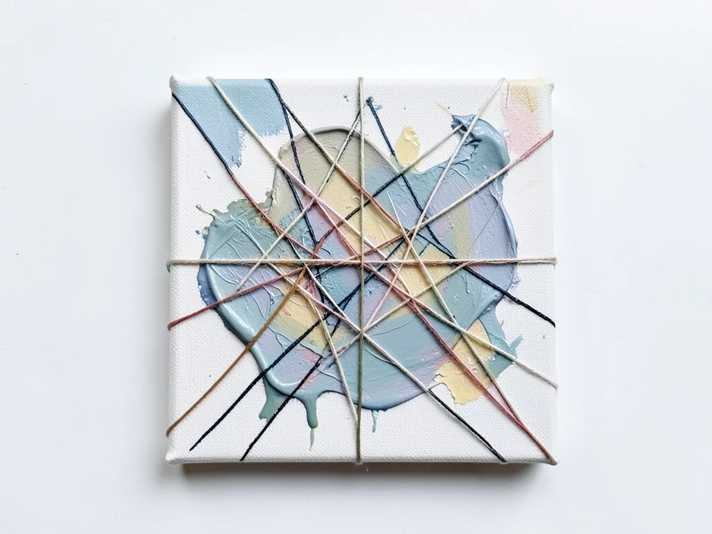 Abstract painting with flowing lines created by pulling string through paint