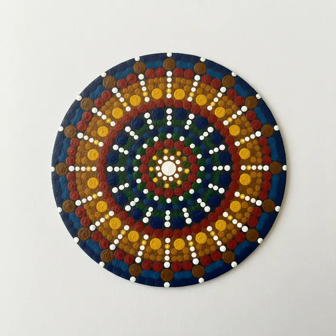 A cork coaster covered in a meticulous lattice design formed from intersecting diagonal lines of small white beads.