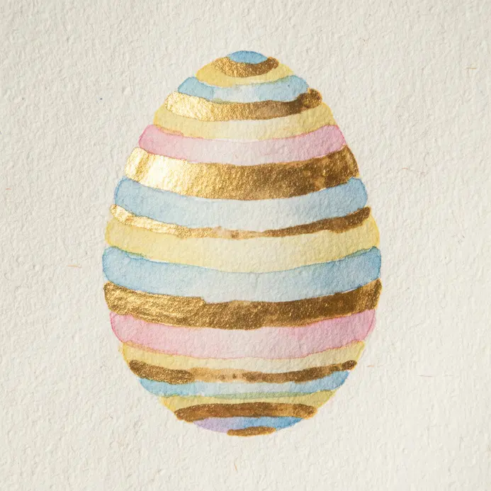 A painted egg with clean horizontal stripe bands and a light pencil guide underneath.