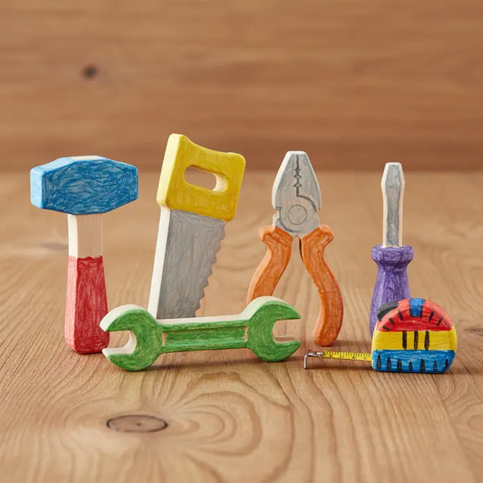 Two small wooden tool shapes painted heavily with yellow and red tempera colors.