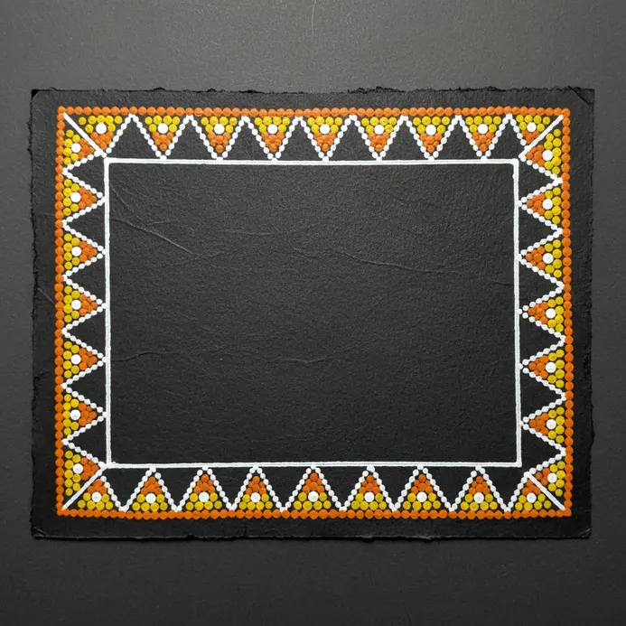 A continuous row of triangle patterns drawn with a fine black marker along the rectangular edge.