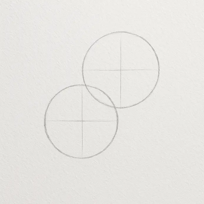 Two lightly sketched overlapping circles on white paper, one slightly higher than the other, forming the cherry guides.