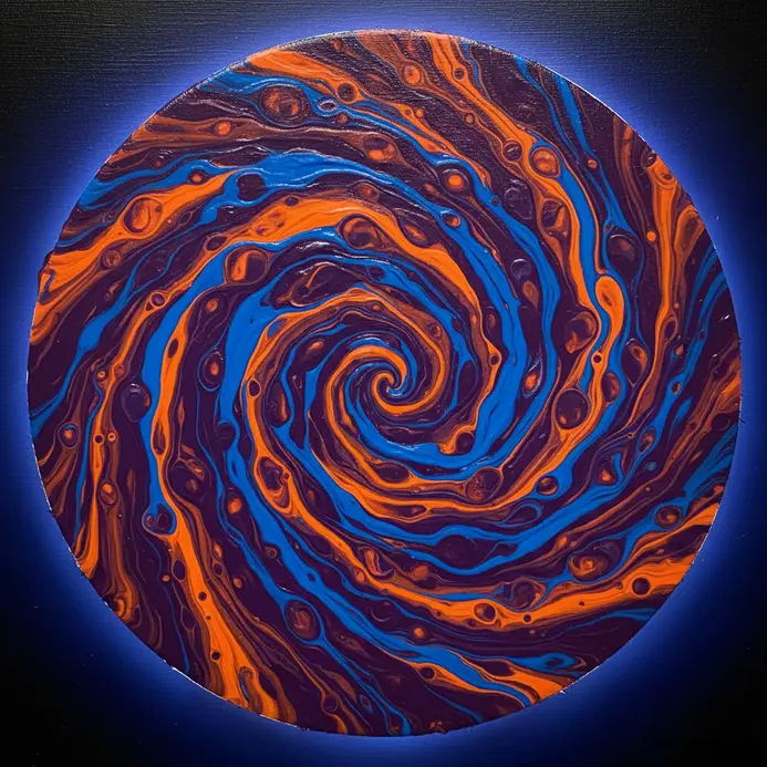 A circular, centrifugal pattern of acrylic paint created by spinning the canvas.