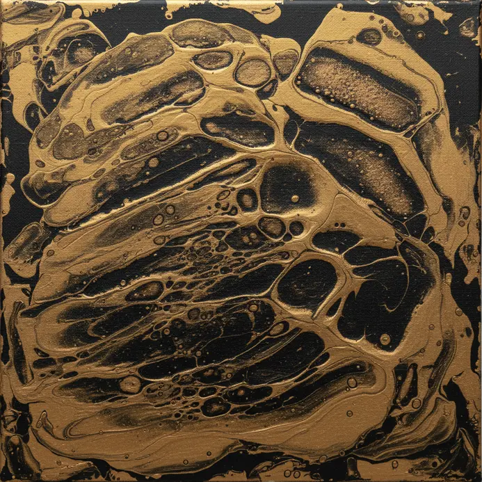 A glossy black background with shimmering gold cells made by wiping.