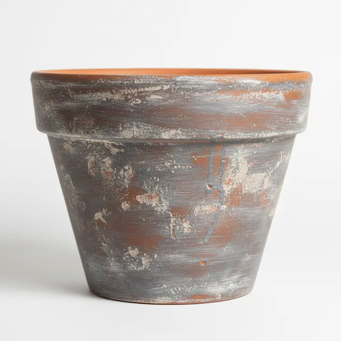 A distressed grey paint wash allows the terracotta color to show through for a rustic effect.
