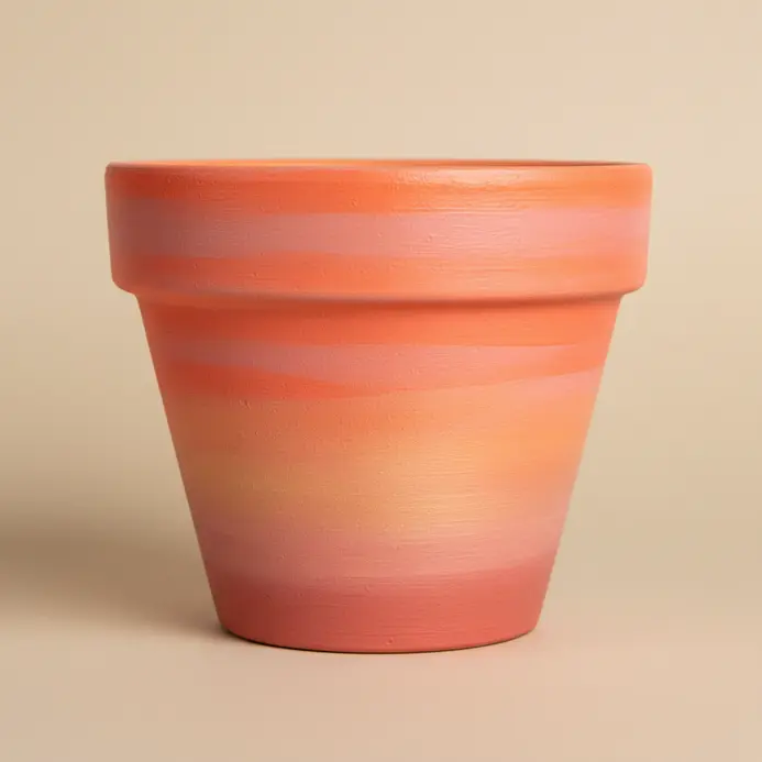 A seamless ombre gradient in sunset colors blends from orange to pink on a pot.