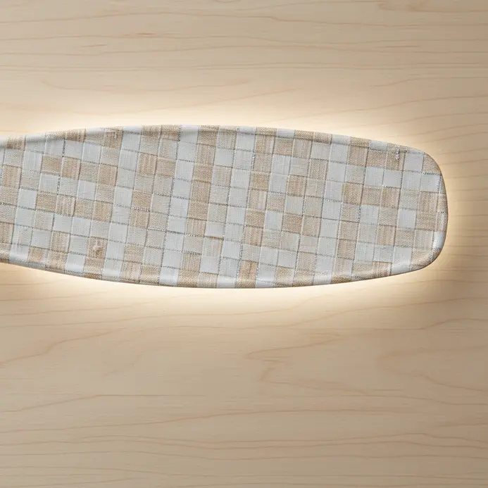 A fan blade completely covered in a self-adhesive vinyl sheet with a woven linen texture.