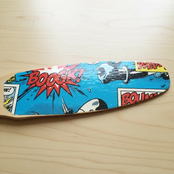 A fan blade featuring a blown-up, high-contrast section of vintage comic book artwork, sealed with a clear coat.