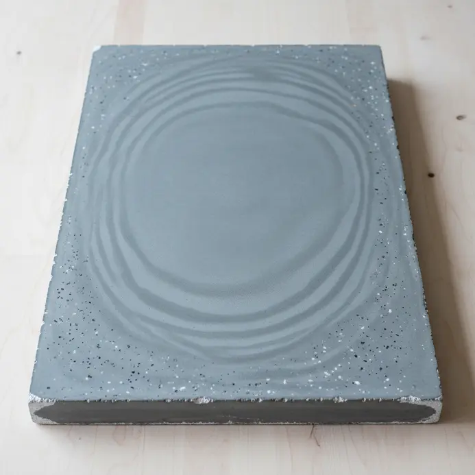 A sleek coffee table featuring a polished gray concrete slab on a simple wooden base.
