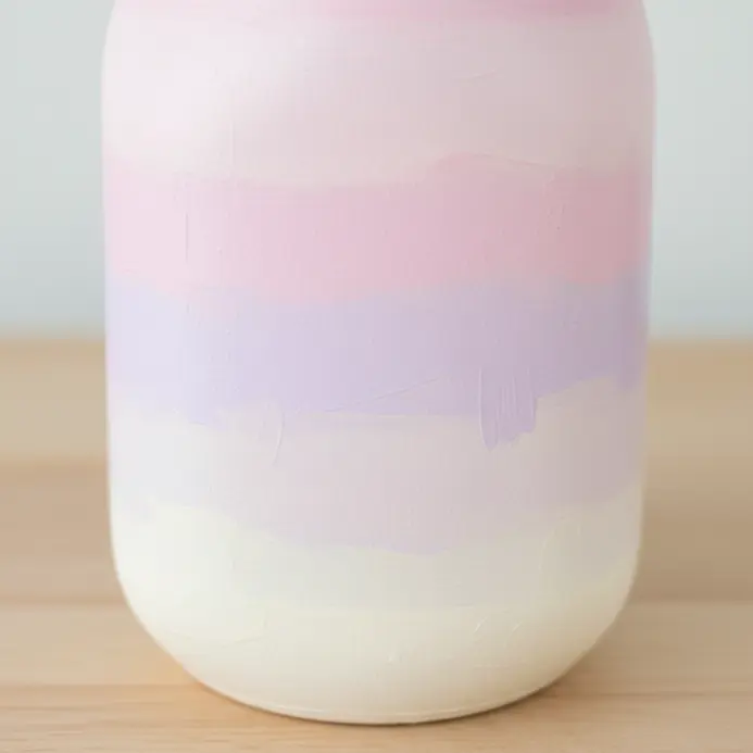 A painted jar showing a smooth gradient from light pink to soft lavender.