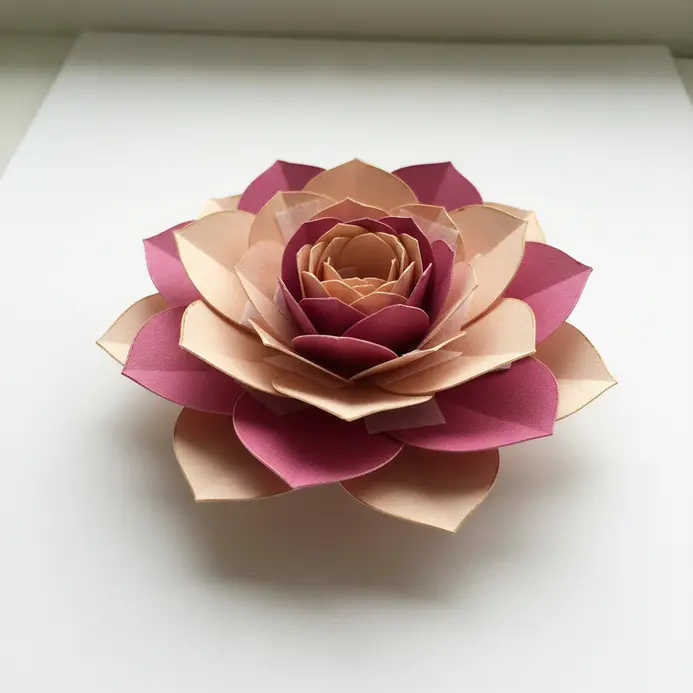 A large decorative flower on a scrapbook page made from multiple layers of pink die-cut paper petals.