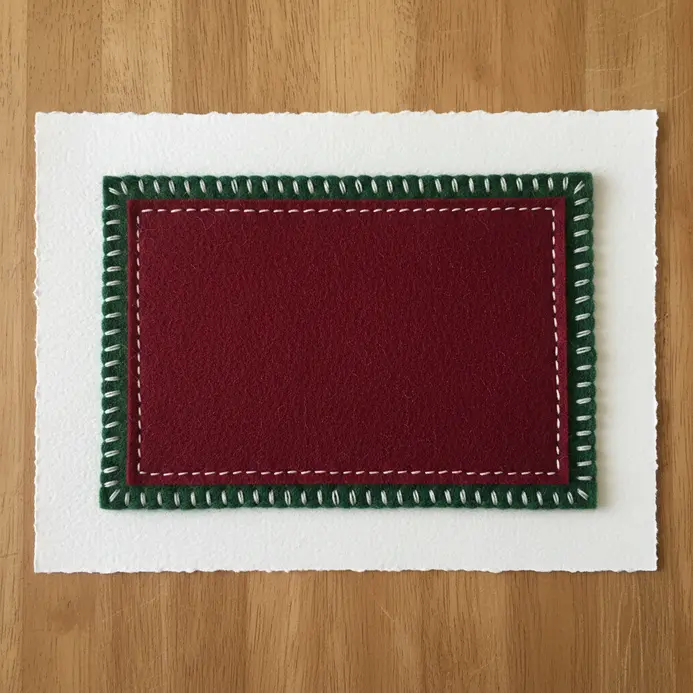 A holiday scrapbook page with a small red felt stocking sewn on as a pocket holding tiny gift tags.