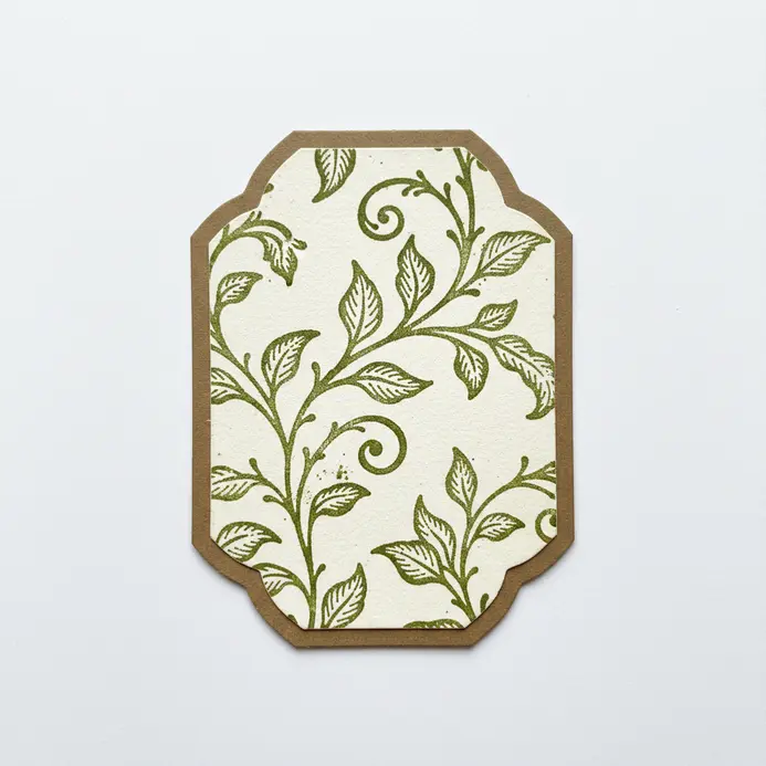 A botanical scrapbook background created with archival ink and detailed rubber stamps of leaves and ferns.