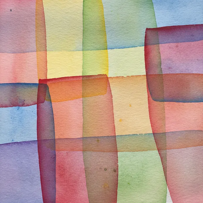 Overlapping transparent slices of red, yellow, and blue watercolor creating new colors where they meet.