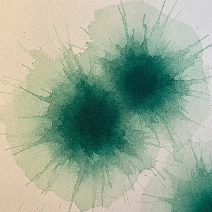 Organic emerald green blots on paper with soft, feathery edges where the ink bled.