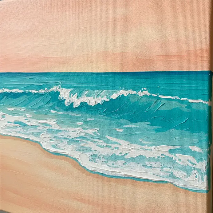 Bright turquoise ocean water with white foam, against a shoreline of white sand under a clear sky.