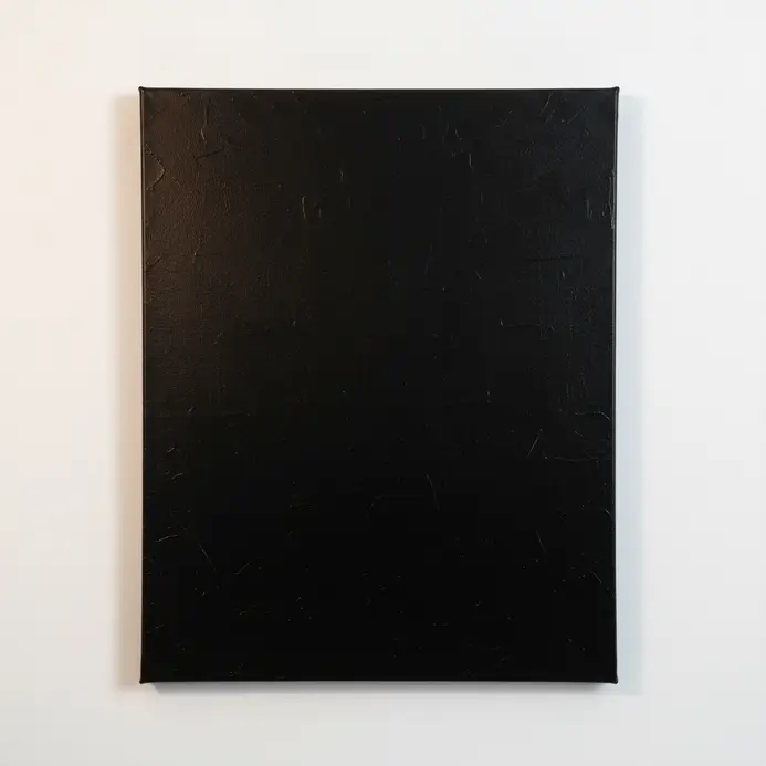 A canvas fully covered in black acrylic paint, creating a dark background for a galaxy painting.