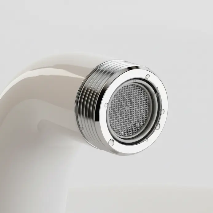 A shiny polished chrome aerator attached to the end of a bathroom faucet spout.