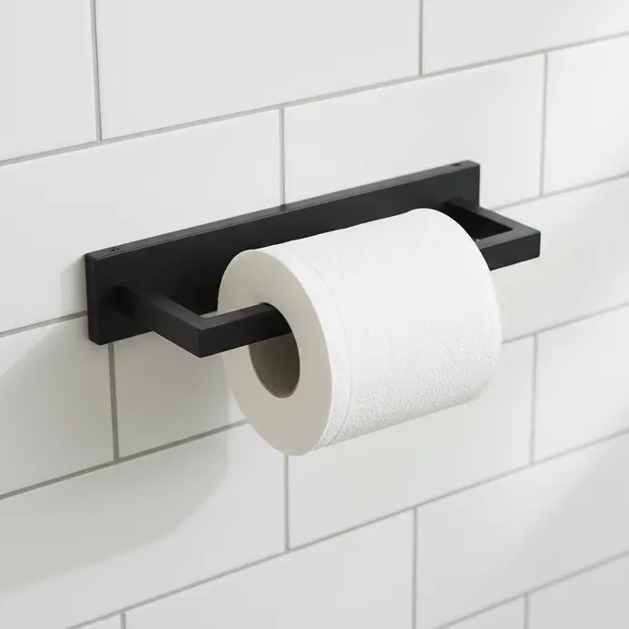 A minimalist black metal toilet paper roll holder with a clean linear design mounted on a white wall.
