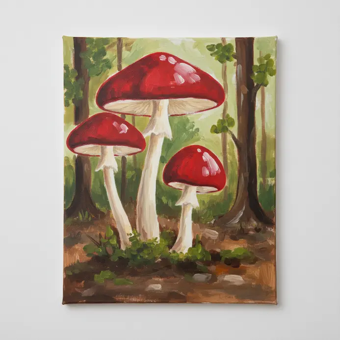 Several cartoon-style mushrooms with red caps and white stems on a brown forest floor painted in acrylic.