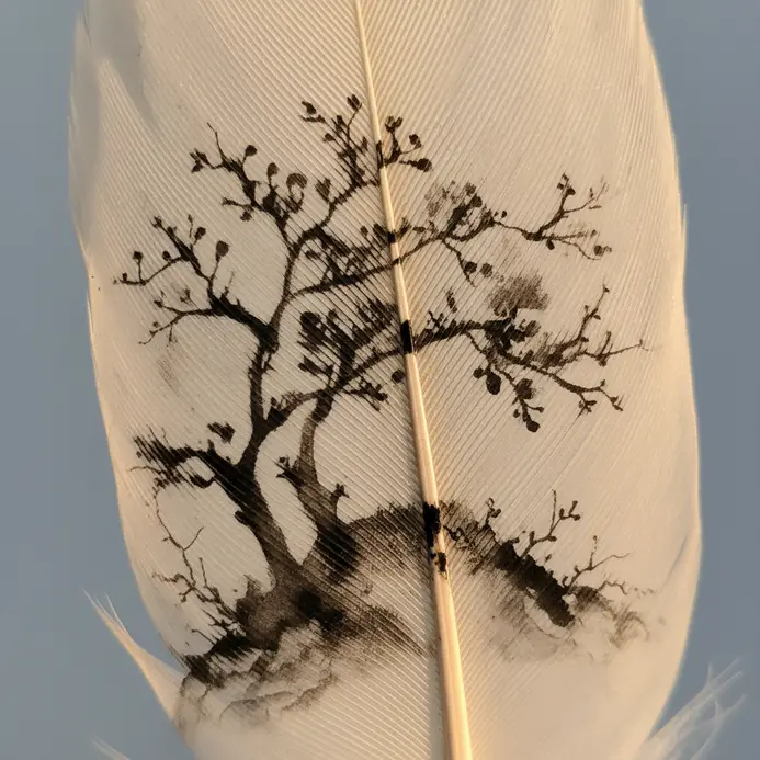 A light-colored feather covered in an interlocking mosaic of black ink triangles.