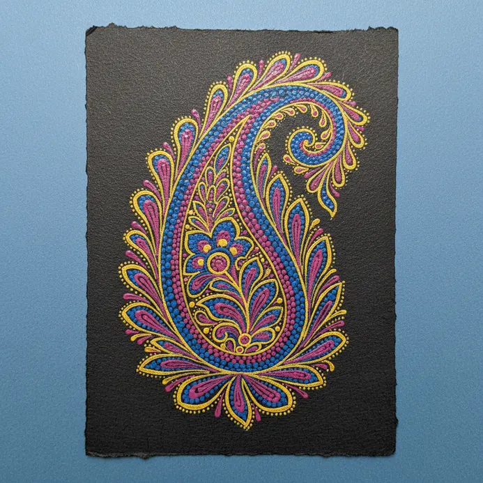 A detailed paisley shape with inner floral and dot patterns, simulating a block print, drawn with fine-tip marker.
