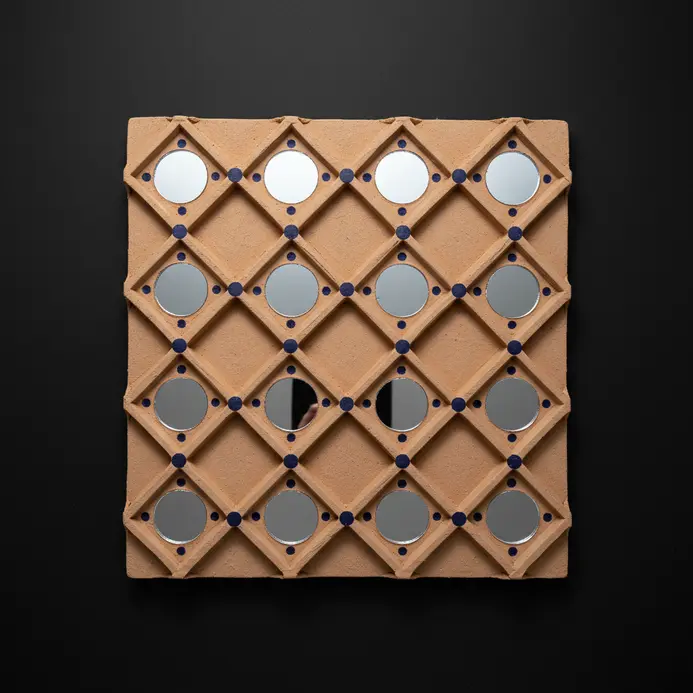 Interlocking diamond clay pattern with small round mirrors placed at each intersection point.