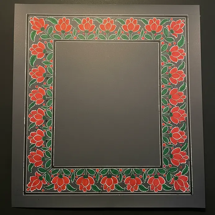 Symmetrical Madhubani border design with repeating floral motifs in red, green, and black.