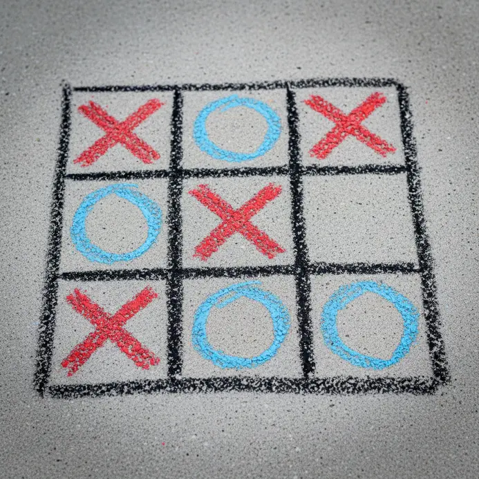 A large tic-tac-toe grid with X and O marks drawn in bold chalk lines.