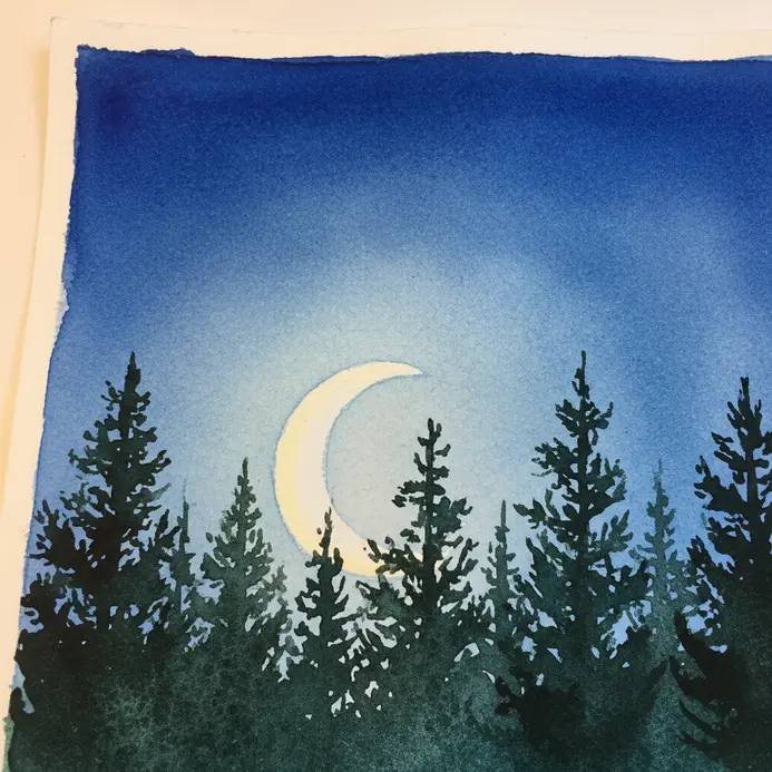 A dark silhouette of pine trees against a blue night sky with a thin crescent moon.