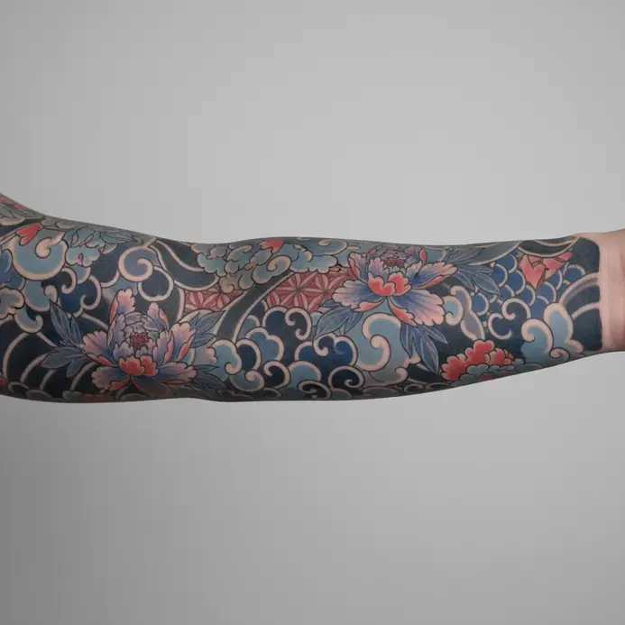 A fully healed and complete tattoo sleeve with detailed background and filler work.