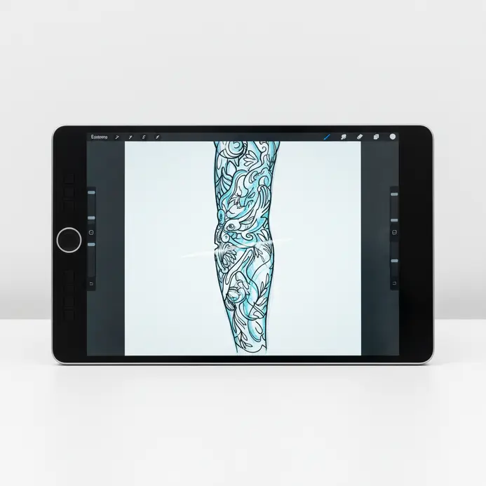 A tattoo artist sketching on a tablet while discussing ideas with a client.
