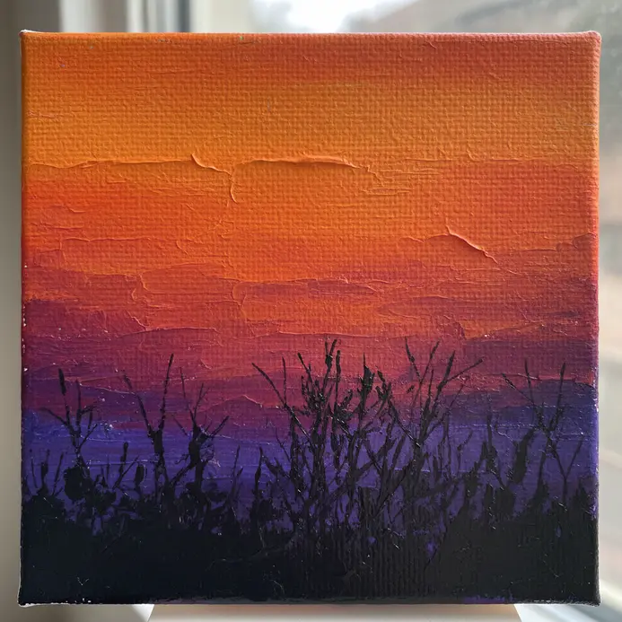 A small canvas painting showing a gradient sunset sky with a dark tree silhouette in the foreground.