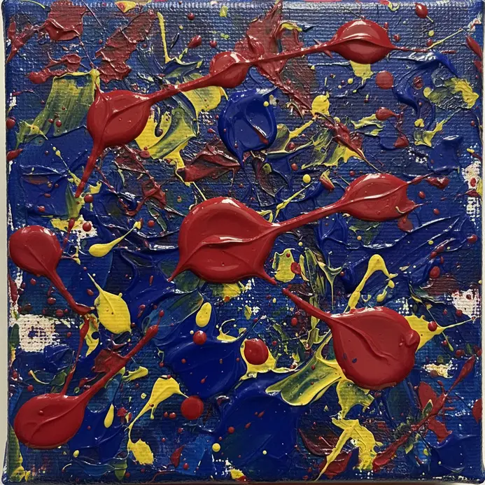 An energetic abstract painting created by splattering multiple bright acrylic colors onto a small canvas.