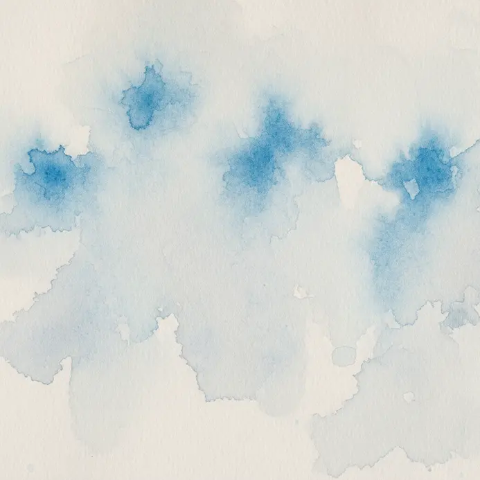 A sheet of thick watercolor paper next to a primed canvas board.