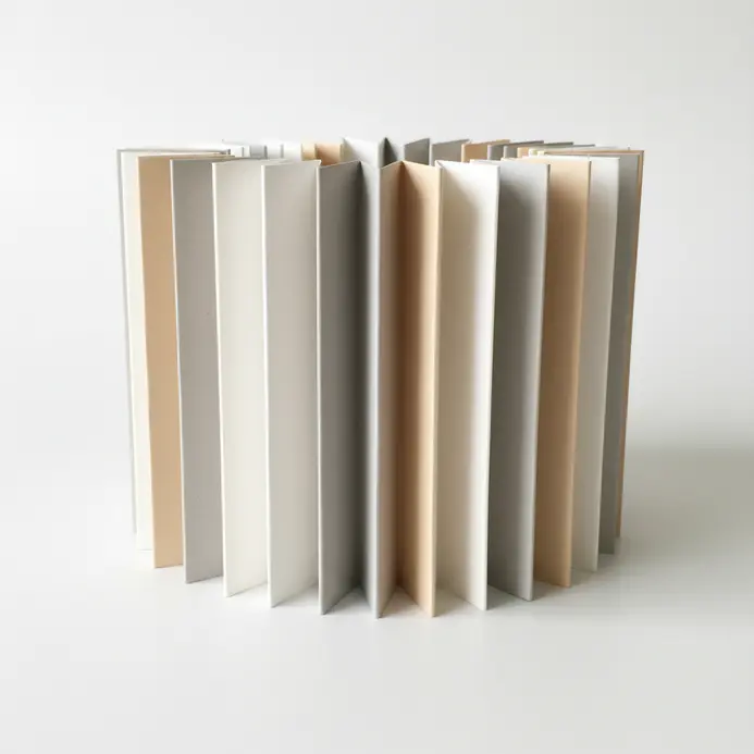 A zigzag accordion paper strip with handwritten tasks standing upright between two paper clips.