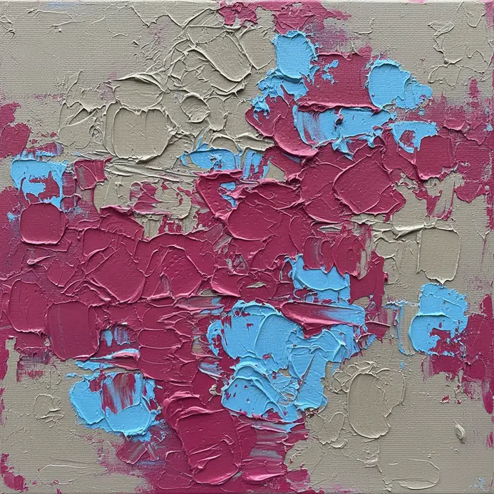 An artist in a studio glances from a vibrant painting to a plain grey wall to reset their color vision.
