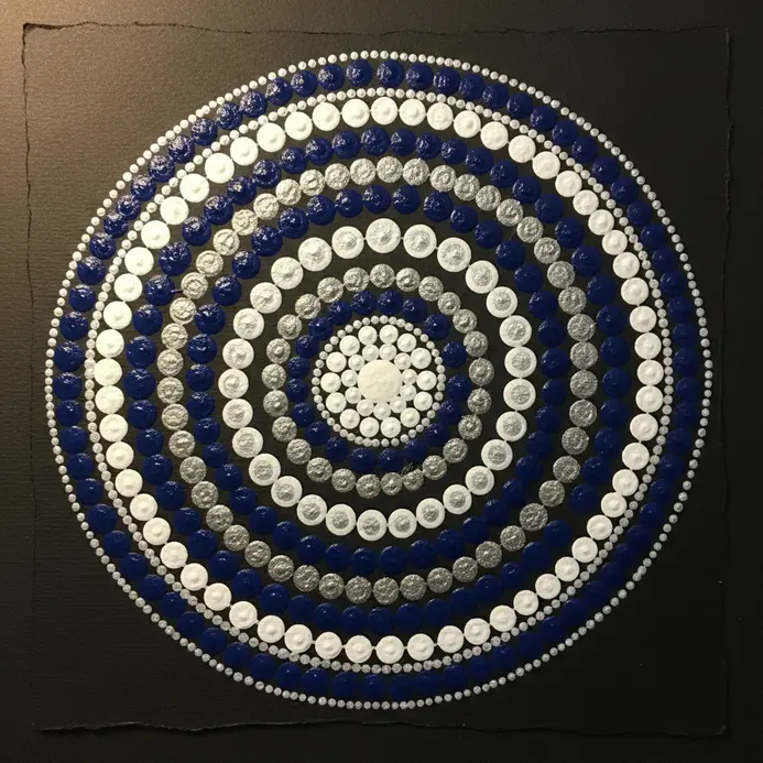 Concentric circles within a mandala, where each circle is defined not by a solid line but by a continuous string of dots.